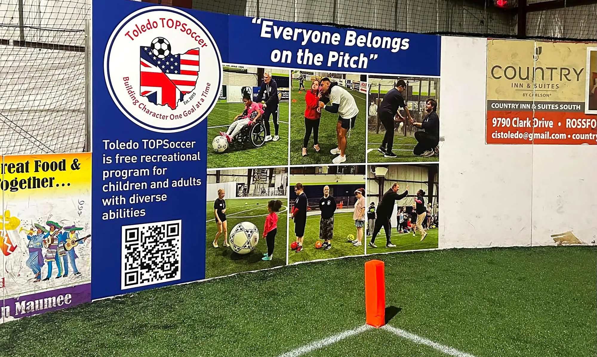 Advertising signboards along the indoor soccer field wall