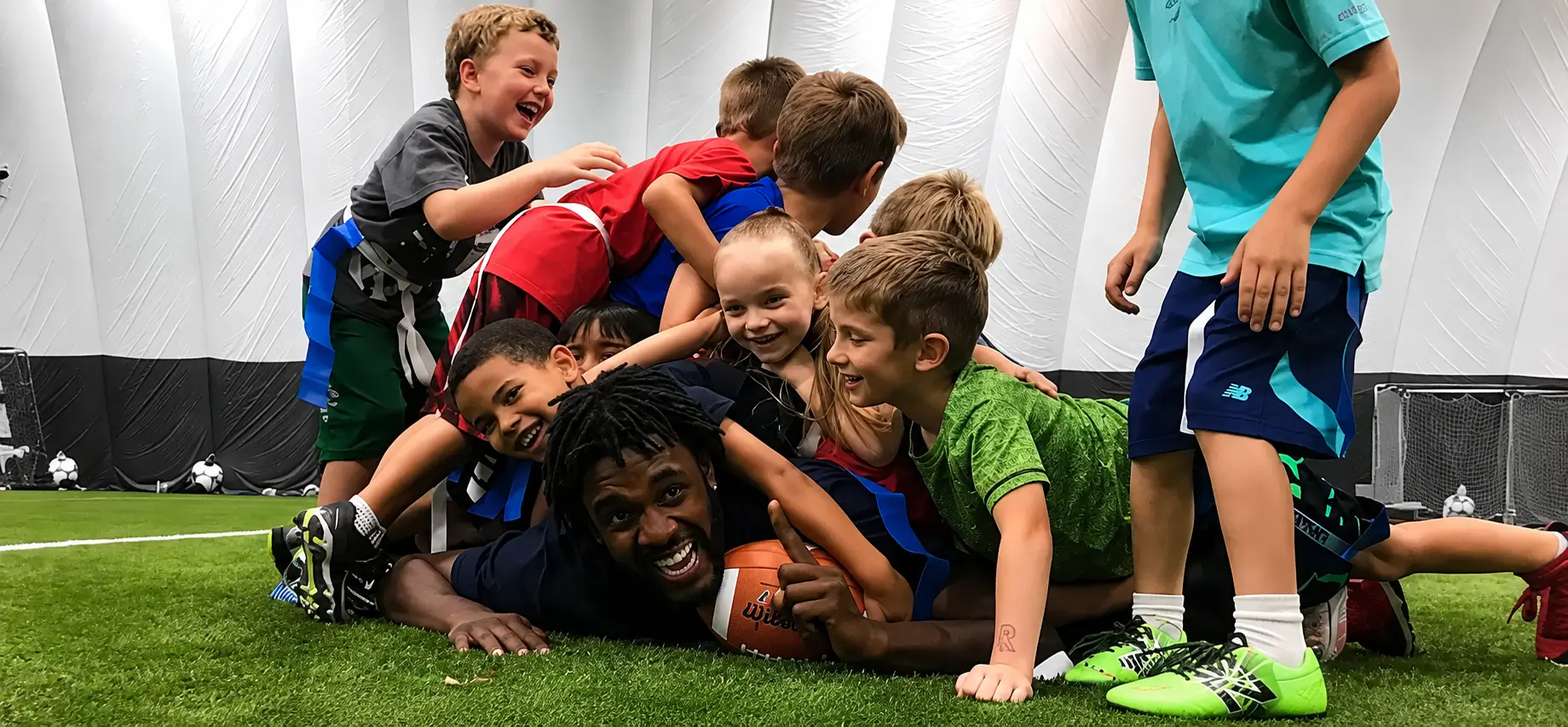 Kids celebrating on the indoor turf at Soccer Centre